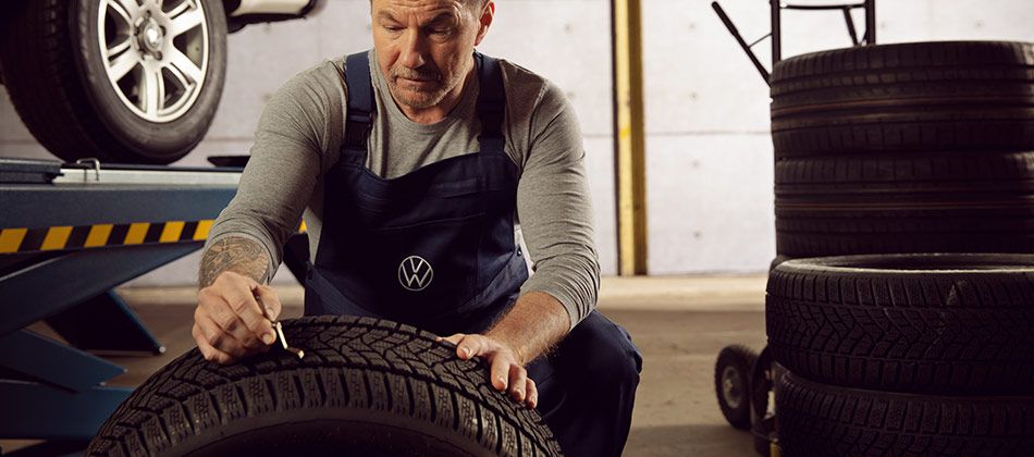 Volkswagen tyre technician working on a tyre