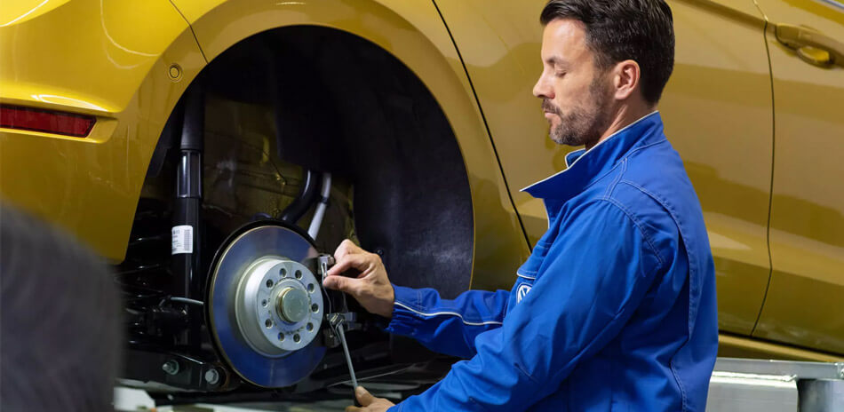 A man working on a VW Golf rear brakes