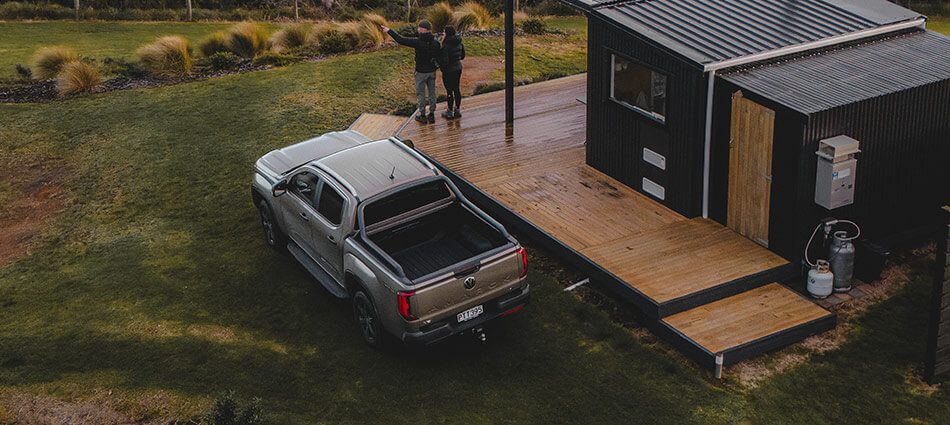 High angle image of a ute parked next to a tiny house