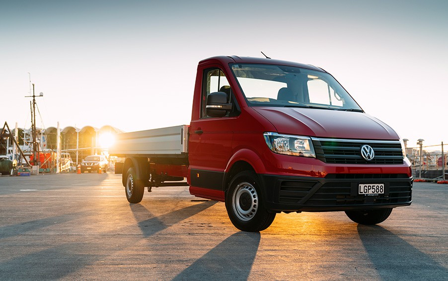 Red chassis van parked by sunset