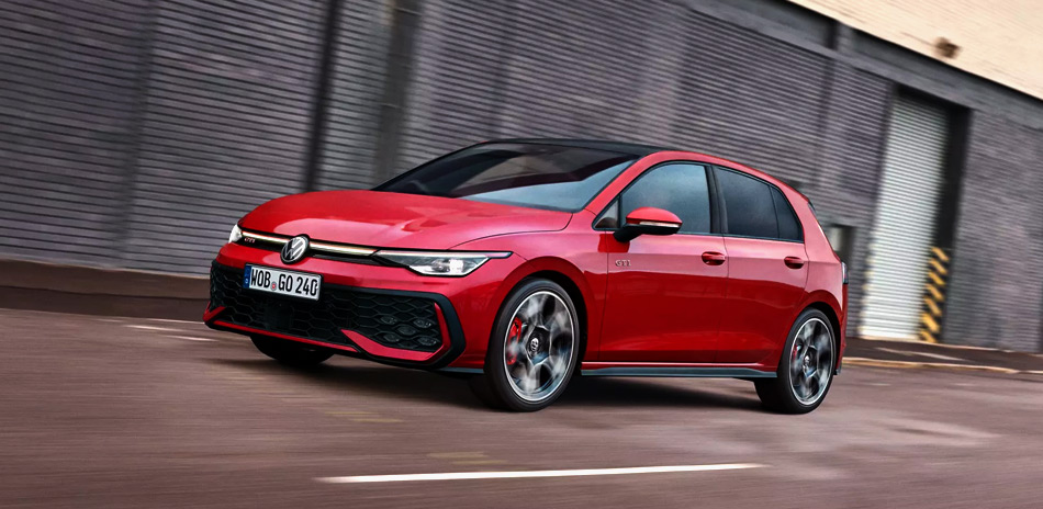 A Red VW Golf GTI driving next to a warehouse