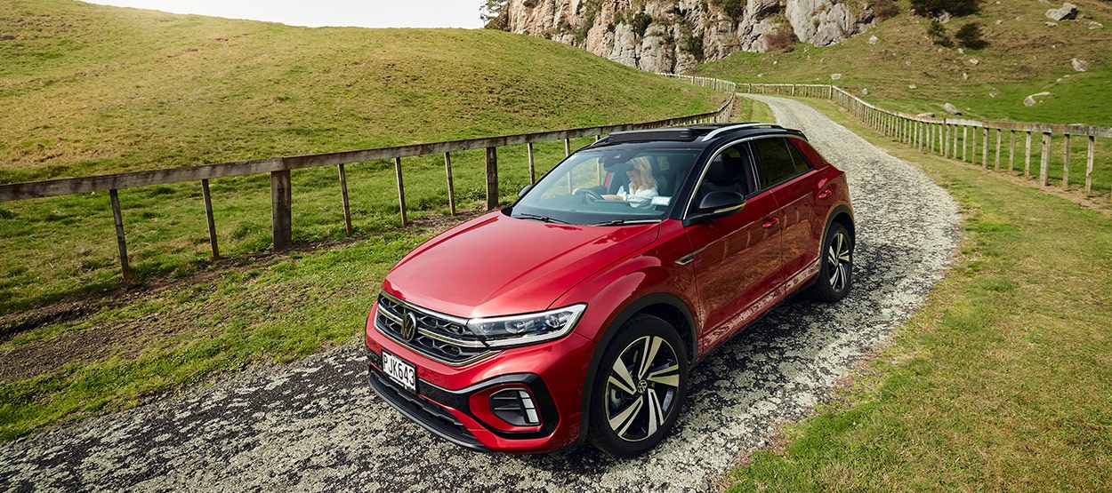 Red Volkswagen SUV on a dirt road