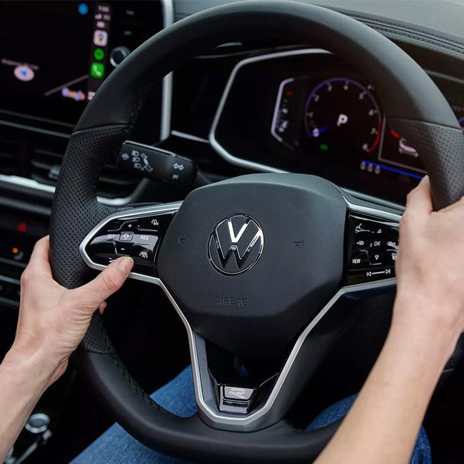 A womans hands on the steering wheel of a T-Roc