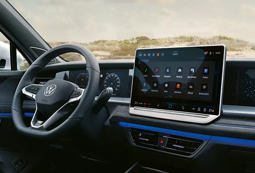 display screen and steering wheel in a Left hand drive interior of a Tayron