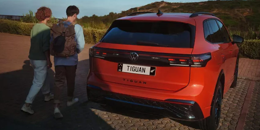 A ute driving over a bridge towing a boat