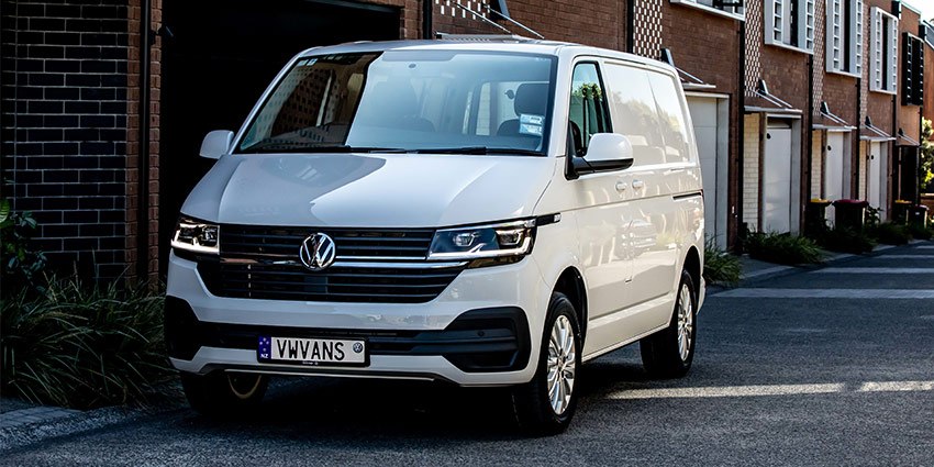 front of a parked white panel van